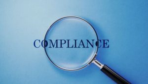 Save Verification Compliance: Magnifying Glass of the word Compliance