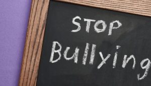 Bullying Complaints on Property: Image shows chalkboard message "Stop Bullying."