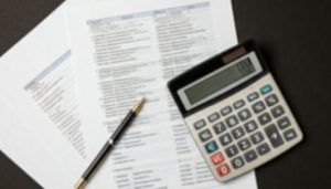 Rounding Reminders. Image shows Calculator sitting atop documents.