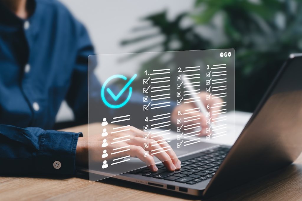 Checklist and clipboard task management verifying the validity and assessment form concept, Businesswomen use laptop to approve requests for document online evaluation test,Paperless online survey; HOTMA interim reexaminations