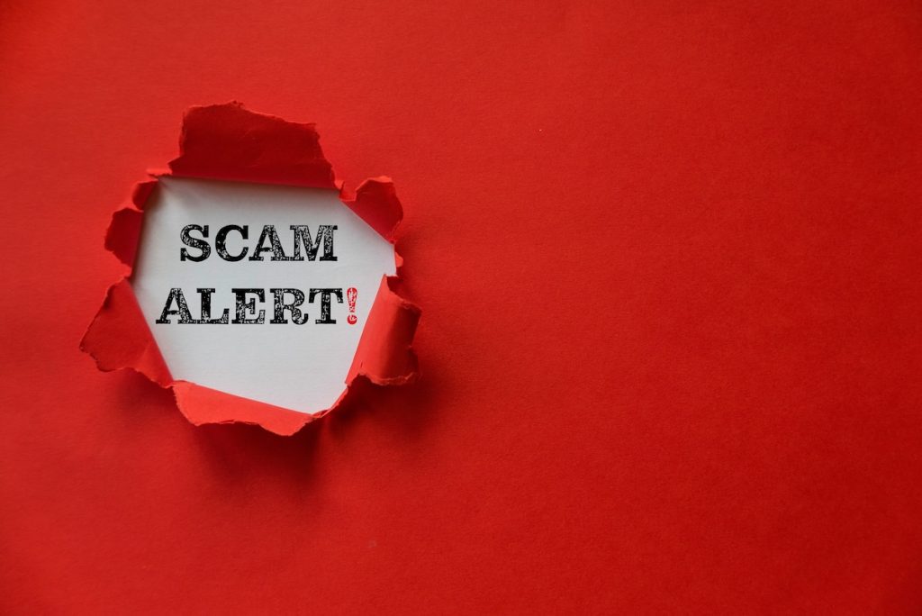 Red torn paper with a text of Scam Alert with copy space; Section 8 scam alert
