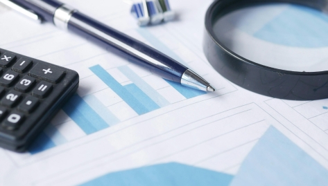 pen, calculator and magnifying glass on top of financial documents, Alternative Operating Cost Factor