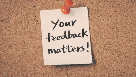 A note pinned to cork board that says "Your feedback matters!"; updated HOTMA forms