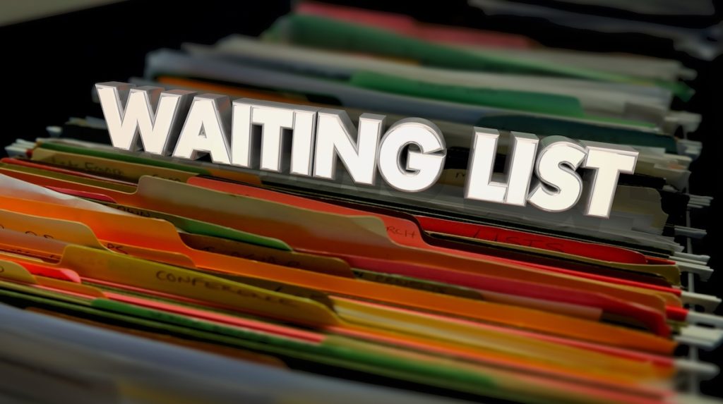 Close-up image of colorful file folders in a filing cabinet with the words “WAITING LIST” displayed prominently across the top