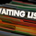 Close-up image of colorful file folders in a filing cabinet with the words “WAITING LIST” displayed prominently across the top