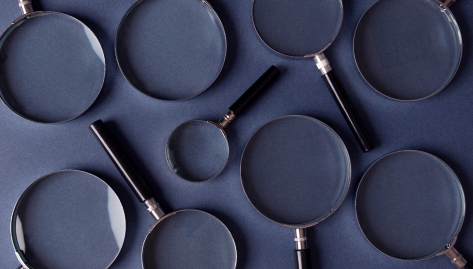 pbca quality control, magnifying glasses on a dark blue background